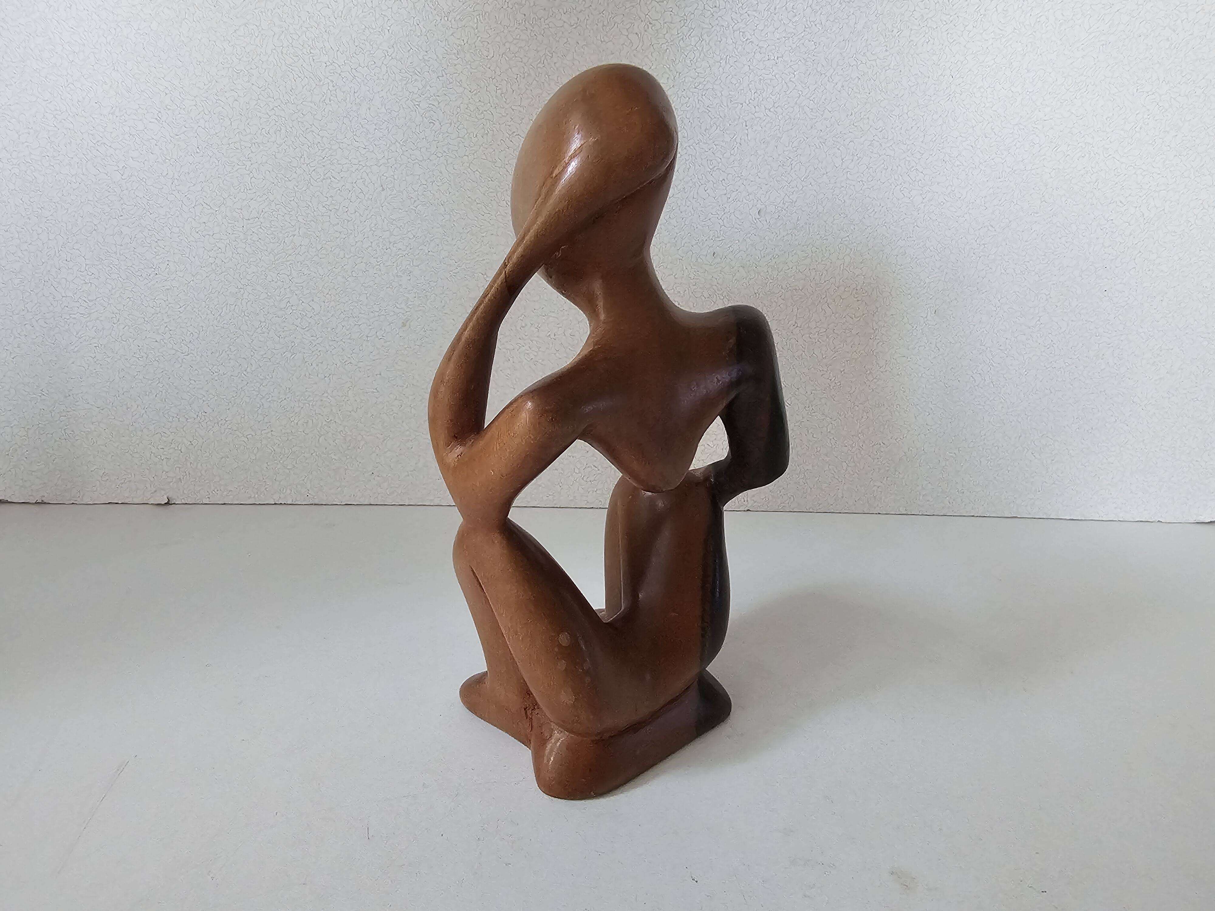 Wooden statuette sculpture of a thinking man design