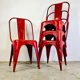 Ensemble de quatre chaises basses en acier rouge