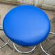 Set of 5 vintage swivel bar stools in blue, red, orange, and yellow.