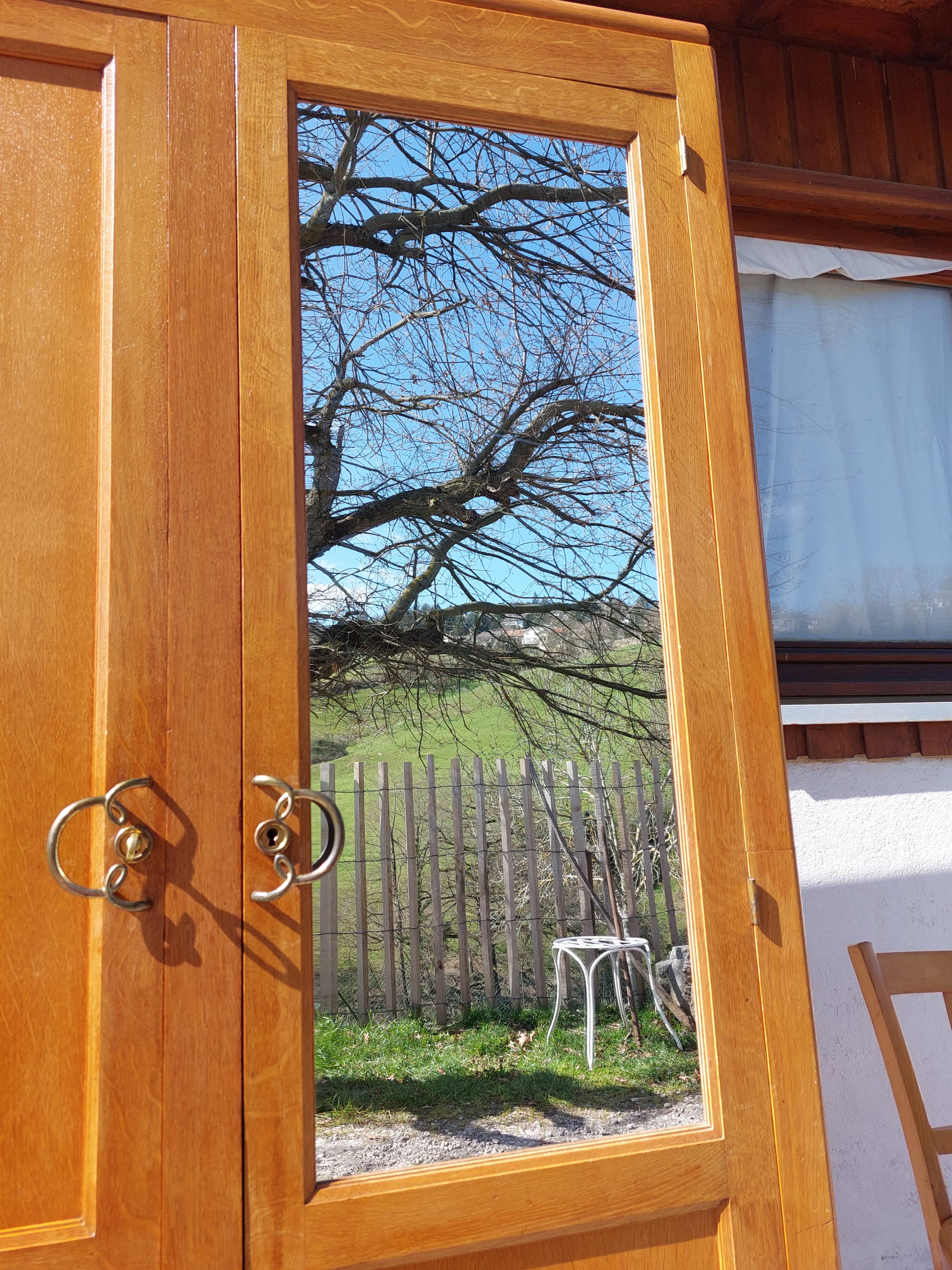 Vintage wardrobe with mirror and tapered legs.