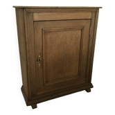 Small piece of furniture with a light oak door.