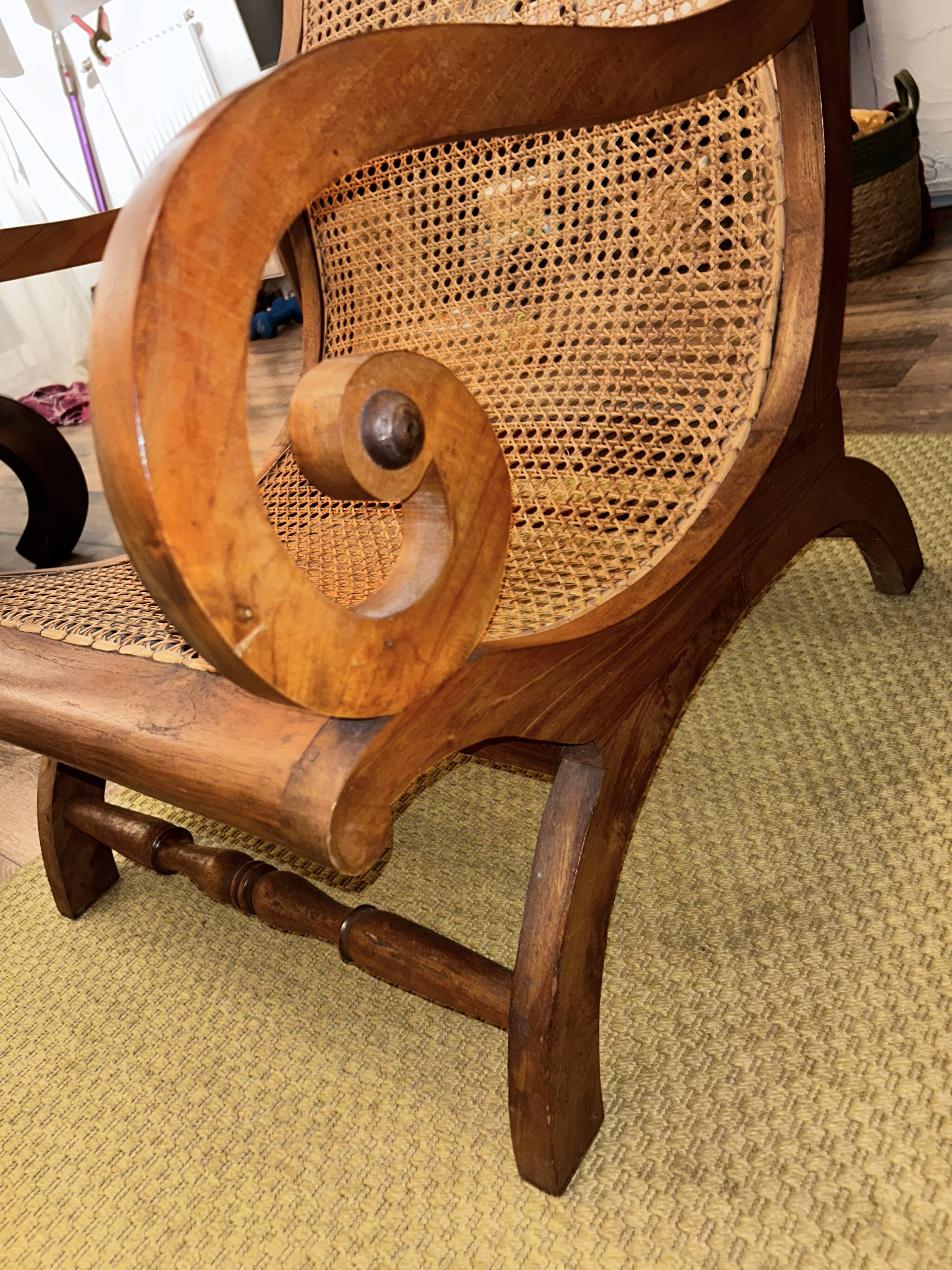 Colonial planter's armchair in solid teak, scroll armrests, caned seat.