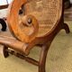 Colonial planter's armchair in solid teak, scroll armrests, caned seat.