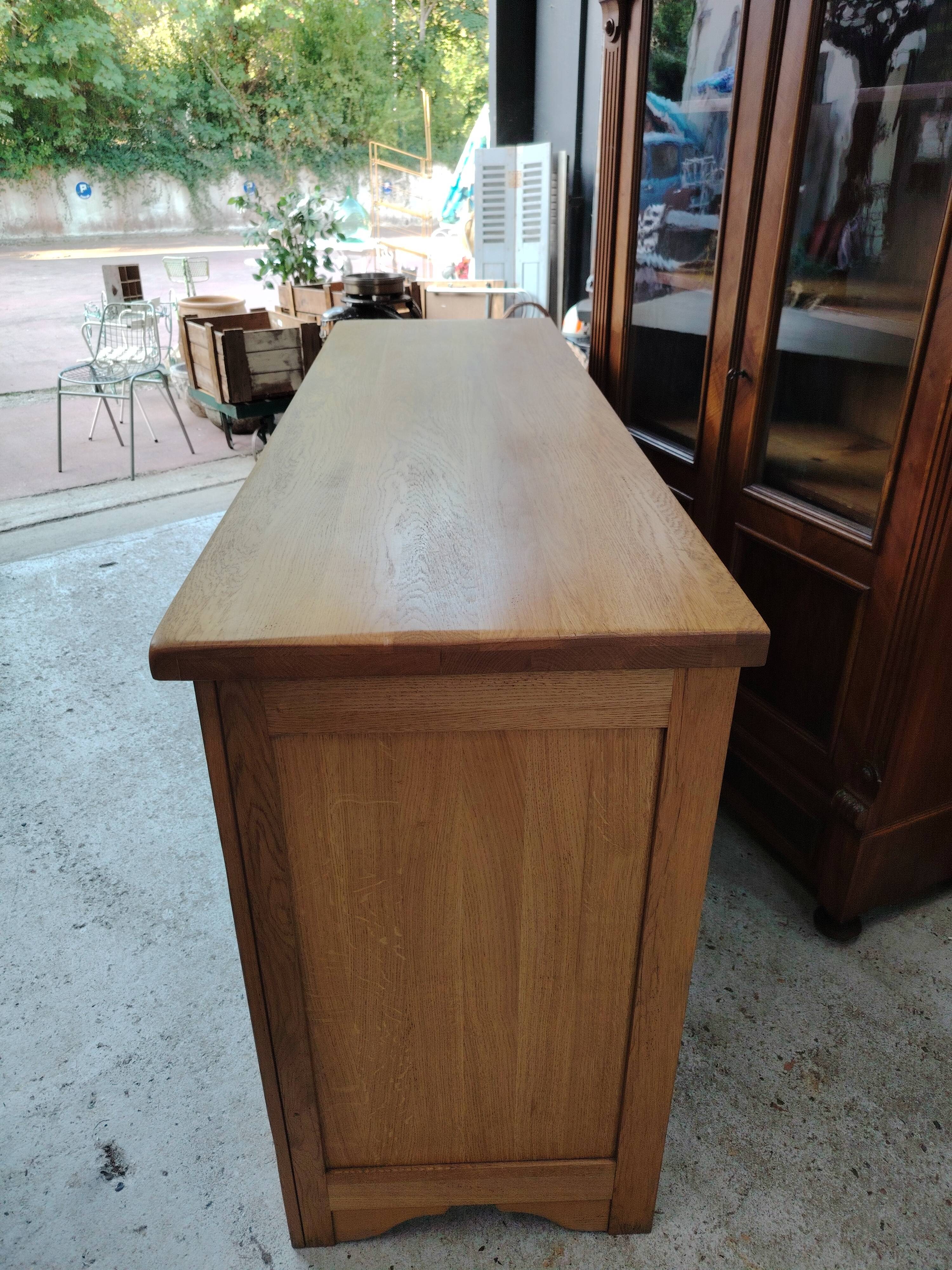 Low sideboard in light solid oak with 3 doors and 1 drawer.