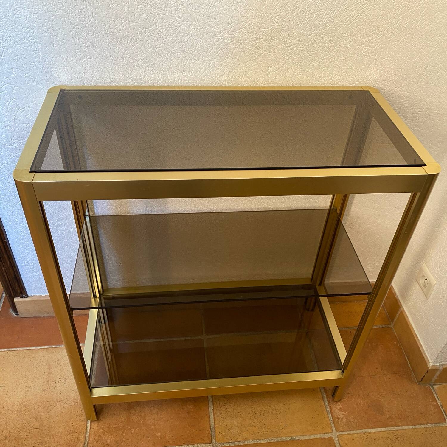Regency style console table, in gilded metal and smoked glass