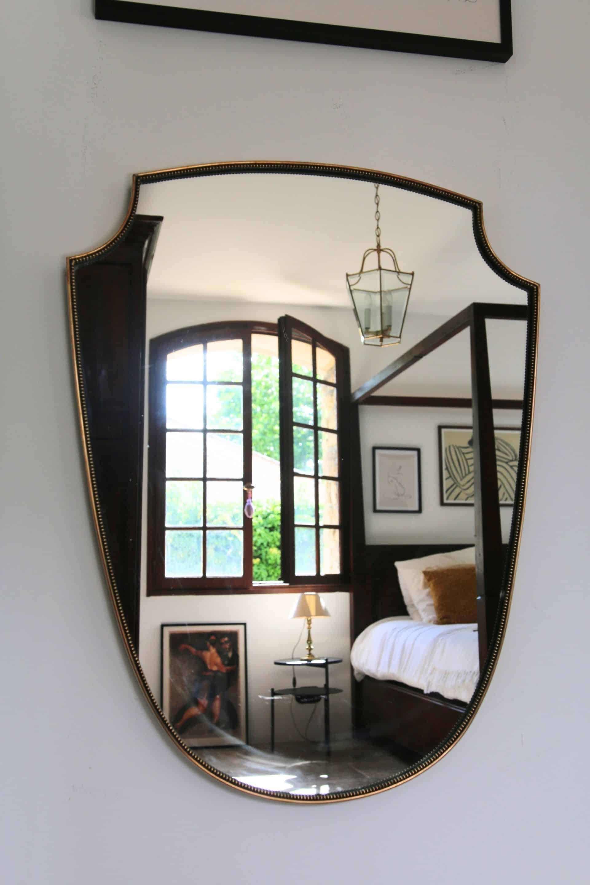 Brass mirror with crest, bead frieze, Italian design style.