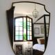 Brass mirror with crest, bead frieze, Italian design style.