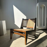 Reclined armchair in canned teak in natural wood