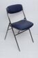 Folding chair in blue faux leather with chrome legs