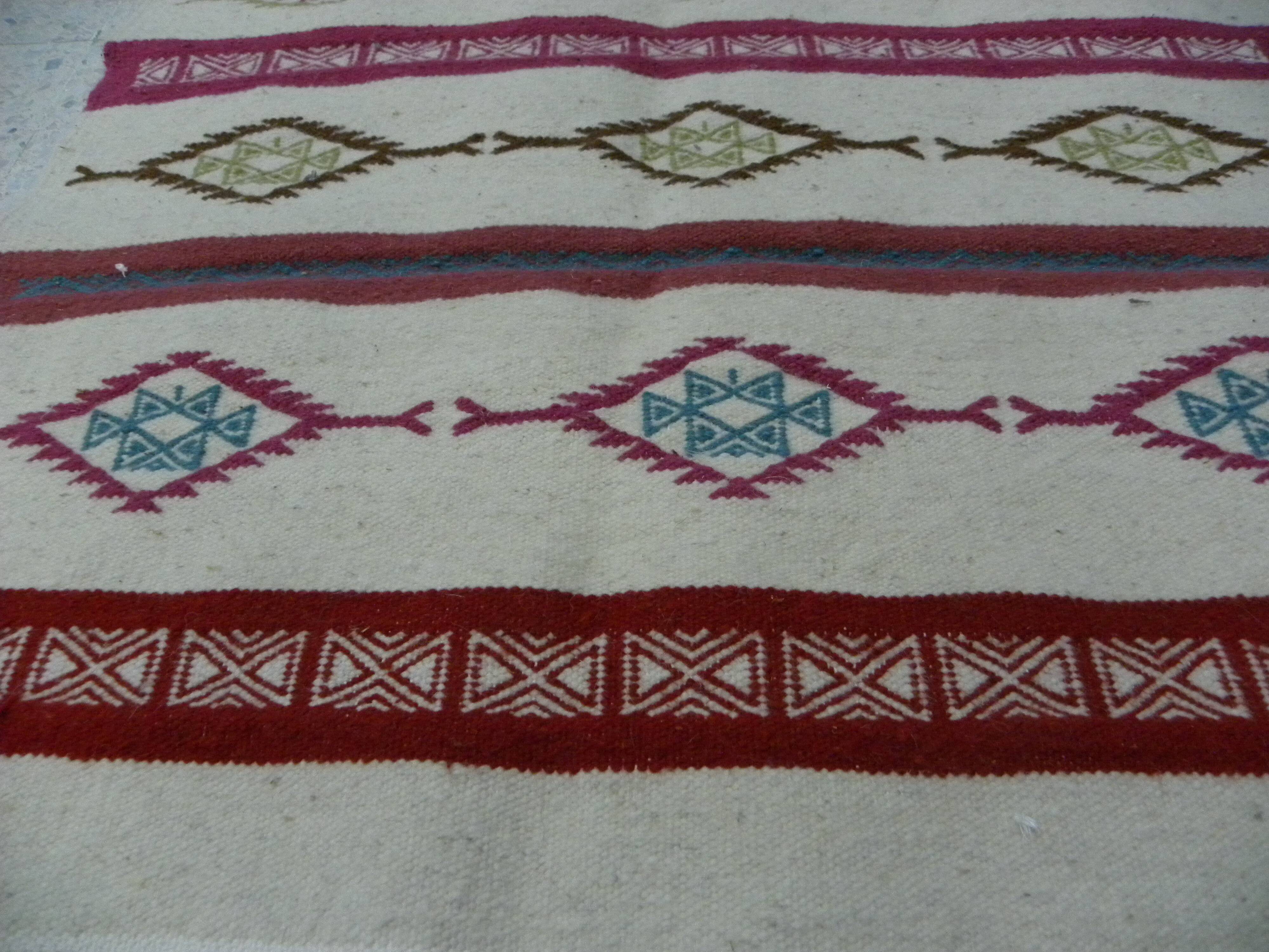 Tribal bohemian kilim rug with geometric pattern in wool.