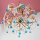 Italian chandelier in gold metal and blue crystal drops