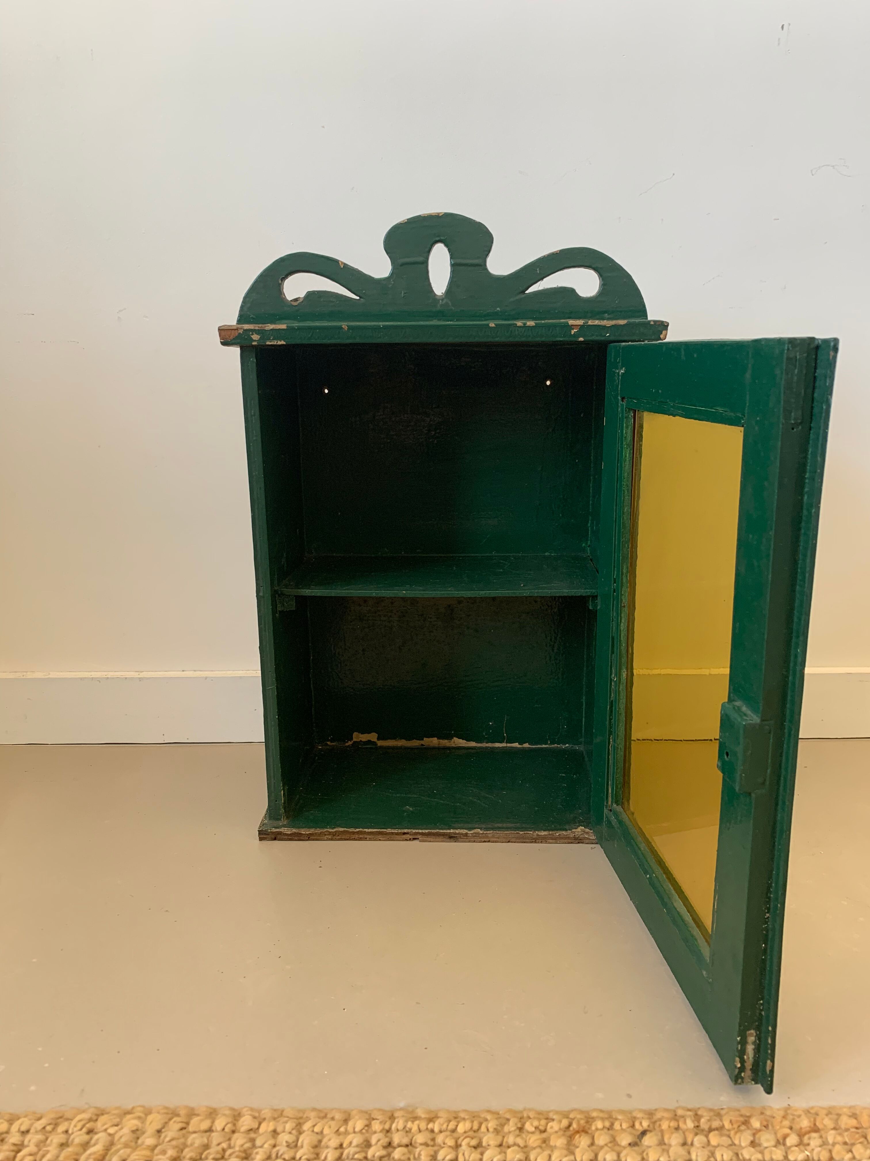 Wall vitrin with pediment