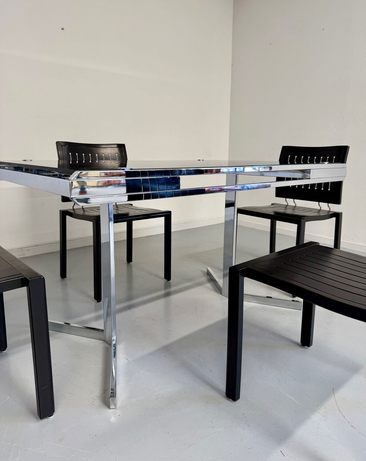 Smoked glass dining table with chrome legs, 1970s design by Roche Bobois.