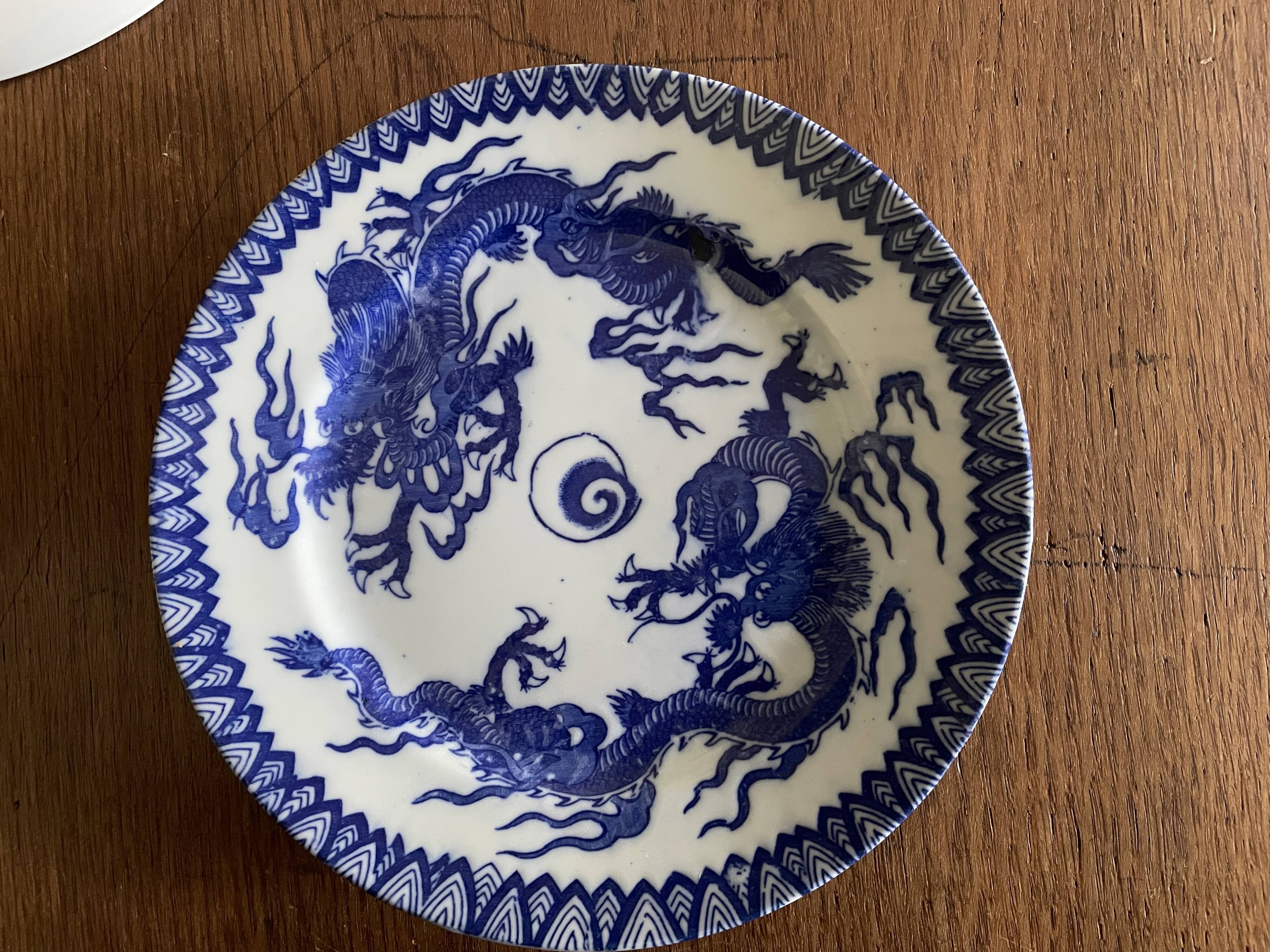 Asian porcelain plates decorated with blue dragons