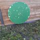 Antique round folding garden table with a green patina.