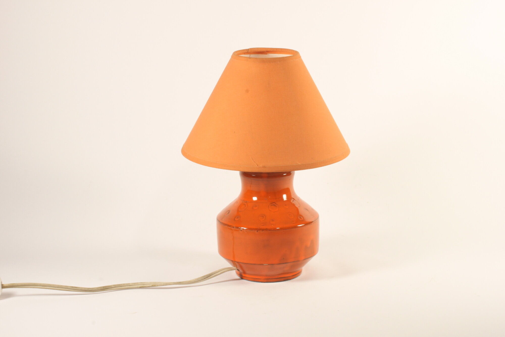 Orange ceramic table lamp with geometric imprints, 1970s.