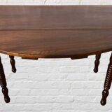 Oval walnut table with flaps
