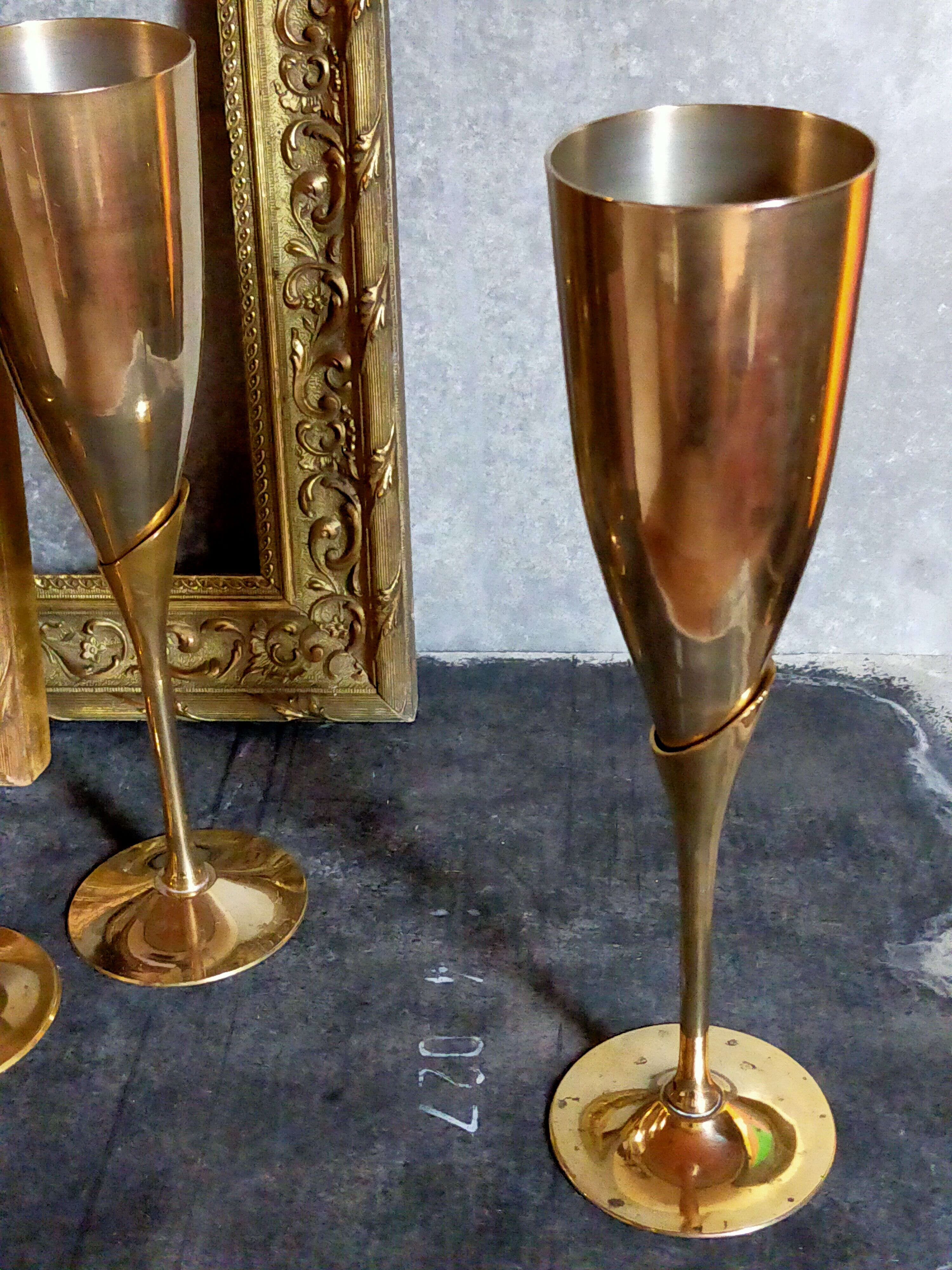 Six brass champagne coupes