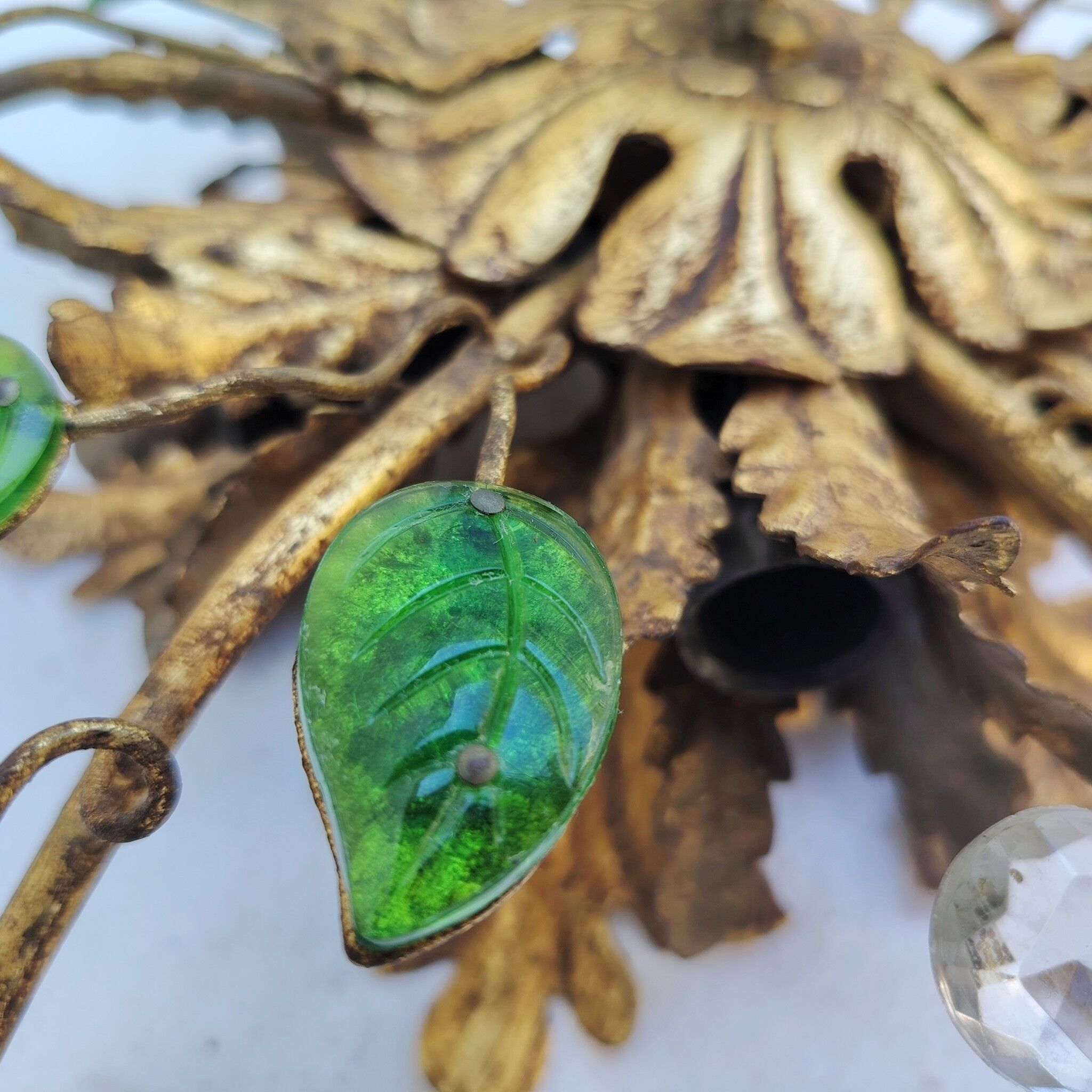 Flower wall light, gilded metal and glass cabochons, attributed to Baguès.
