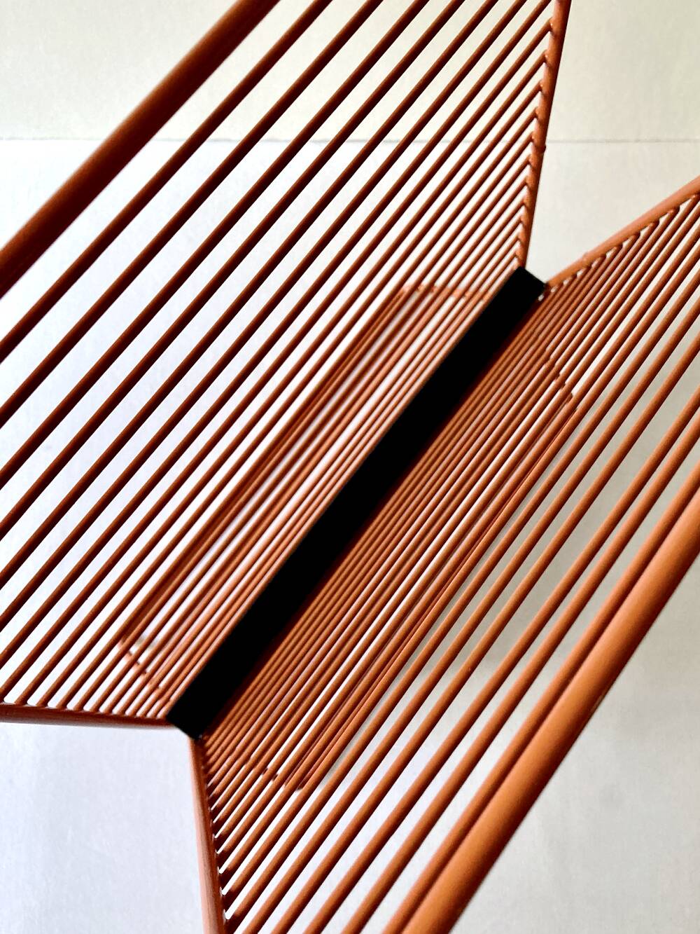 Wire metal magazine rack with triangular compartment, 1950s.