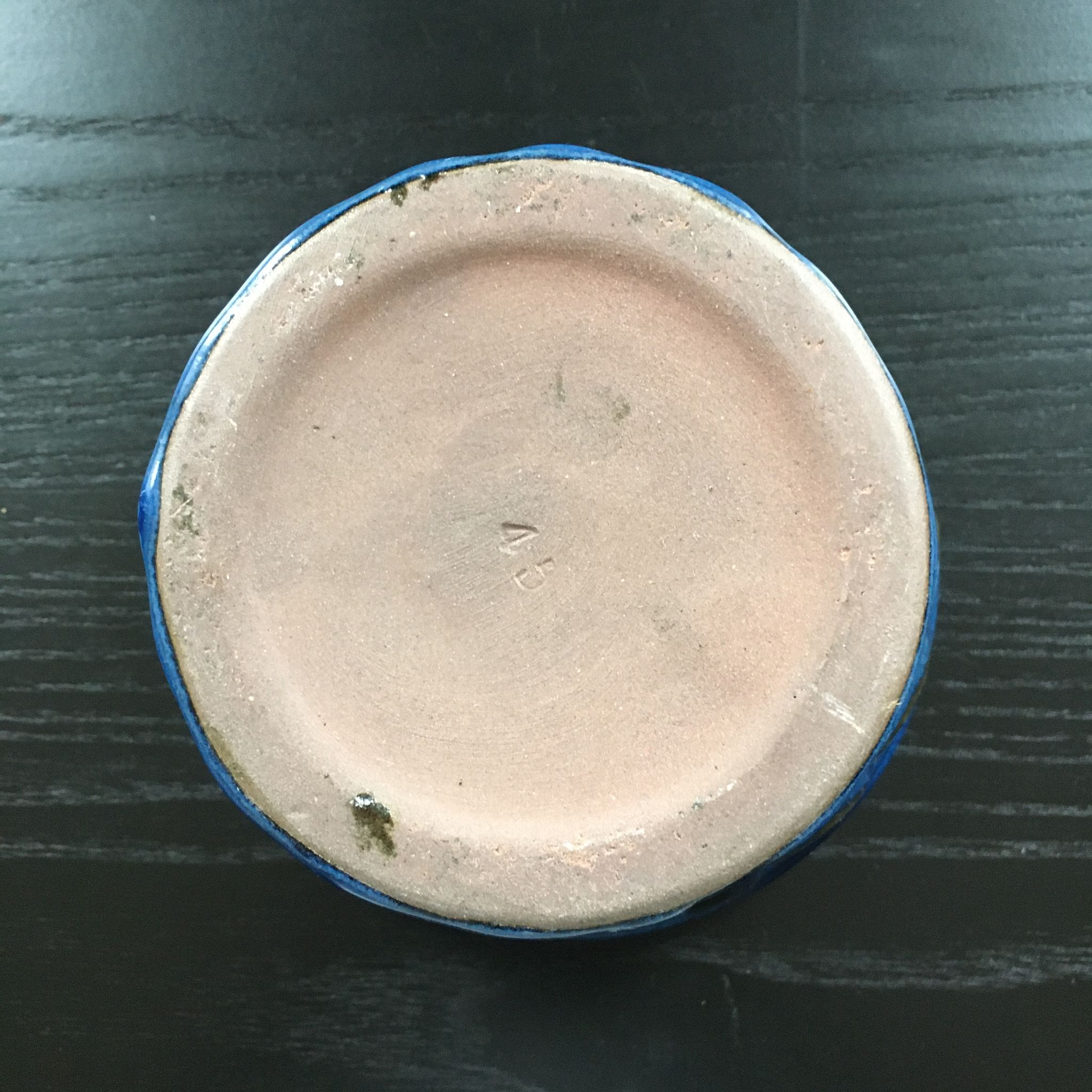 Navy blue stoneware pot.