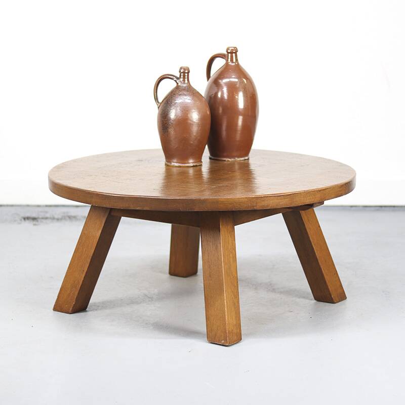 Large rustic vintage coffee table in a round brutalist style.