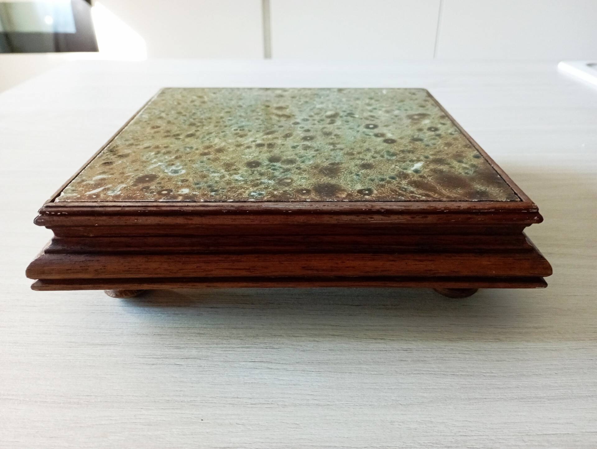 Old wood and ceramic trivet