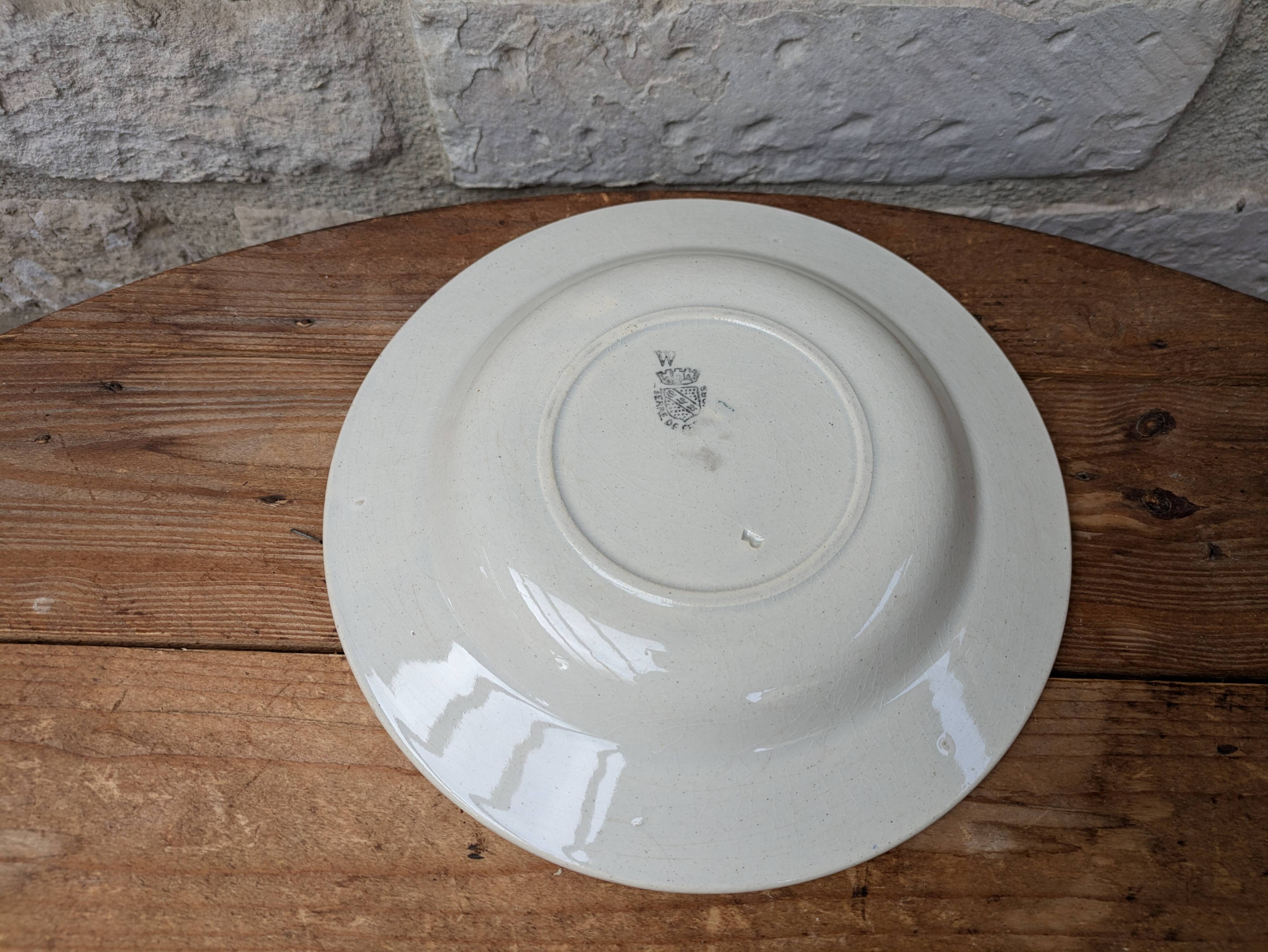 Old deep iron earth plate with blue flower pattern