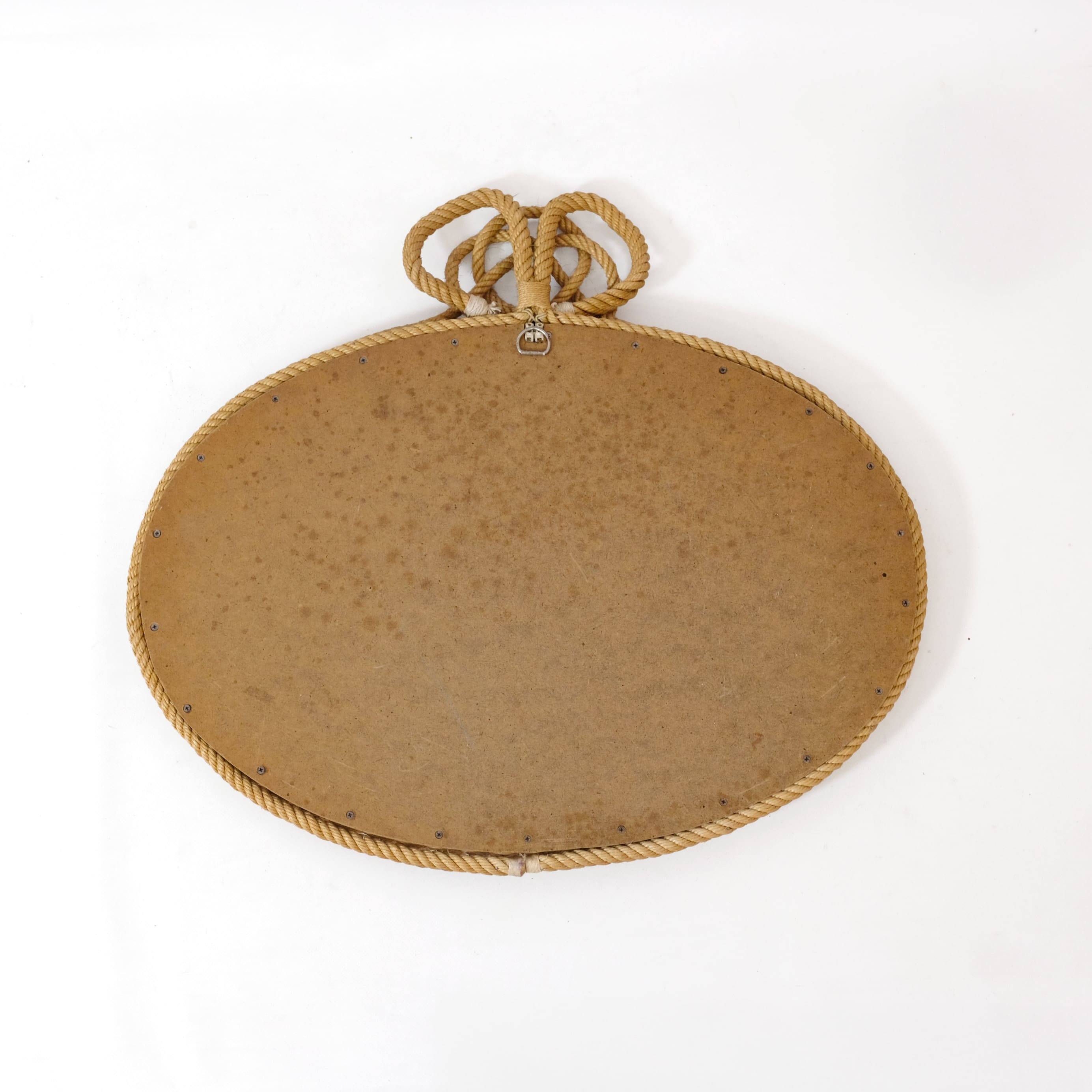 Large oval mirror in rope with pediment, 64cm x 56.5cm.
