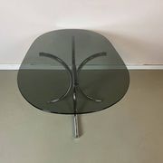 Vintage coffee table from the 70s in smoked glass and chrome, oval, Space Age style.