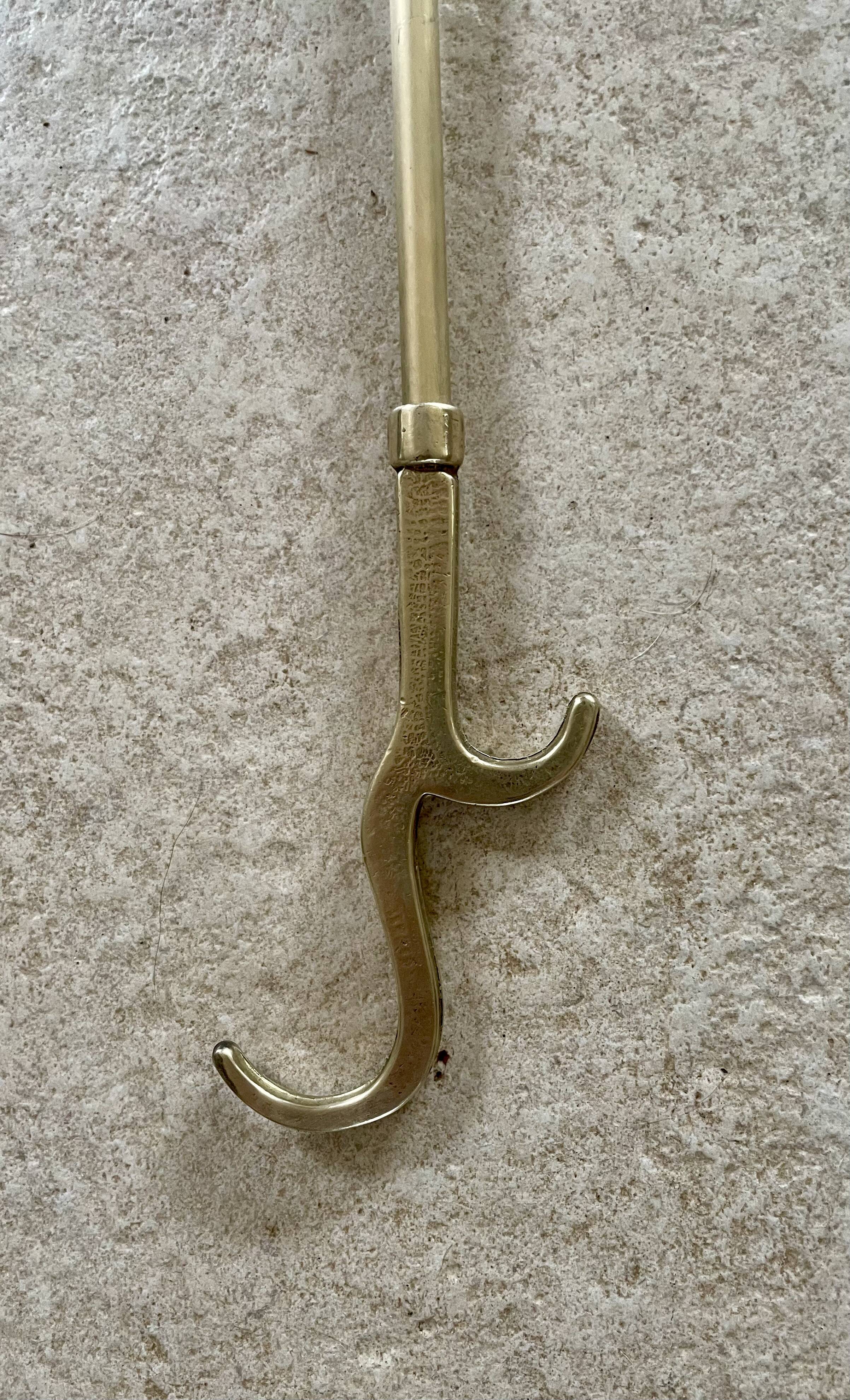 Brass fireplace tools in the style of Maison Baguès.