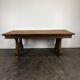 Renaissance-style oak dining table with lyre legs.