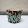 Old earthenware pot with ivy decoration.