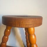 Round tripod stool in carved wood