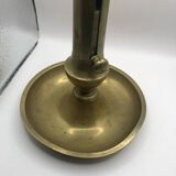 Candle holder with a pusher