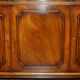 Vintage mahogany buffet with three drawers and shelves.