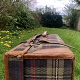 Old large suitcase in leather and tartan fabric