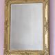 Richly carved antique gilded mirror