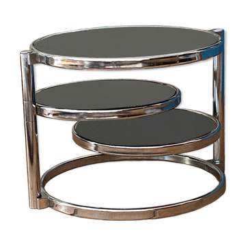 Coffee table with pivoting metal and black glass elements.
