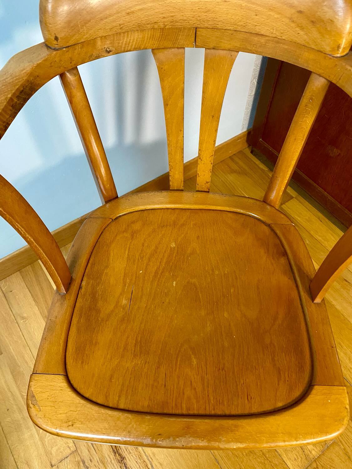 Antique curved wooden armchair in Baumann style