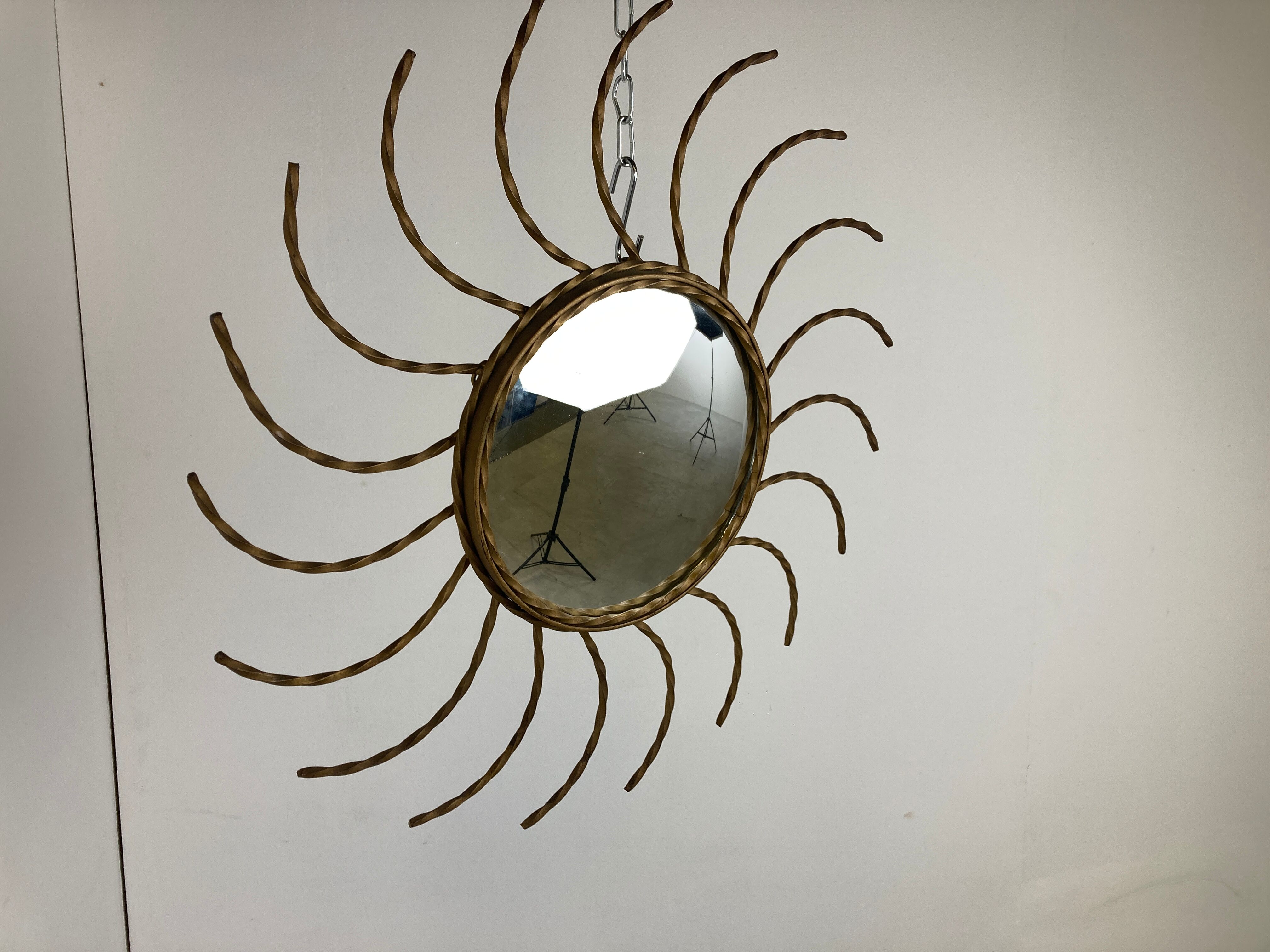 Mid century gold sunburst mirror with convex glass.