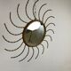 Mid century gold sunburst mirror with convex glass.