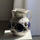 Very large vintage ceramic carafe in white glazed with blue floral decoration.