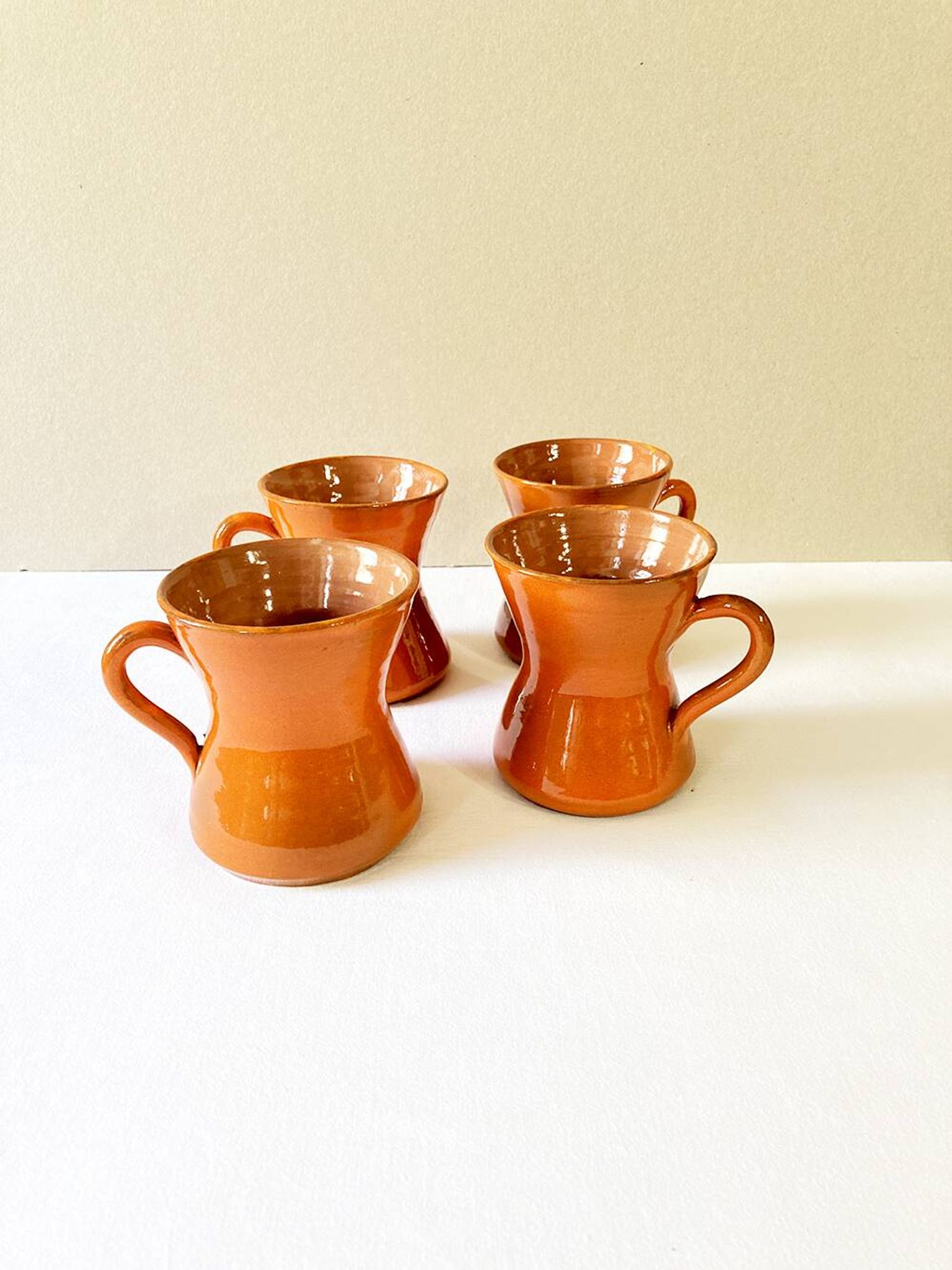 4 large orange enameled ceramic cups, signed