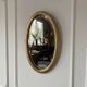 Miroir doré ovale ancien glace biseautée