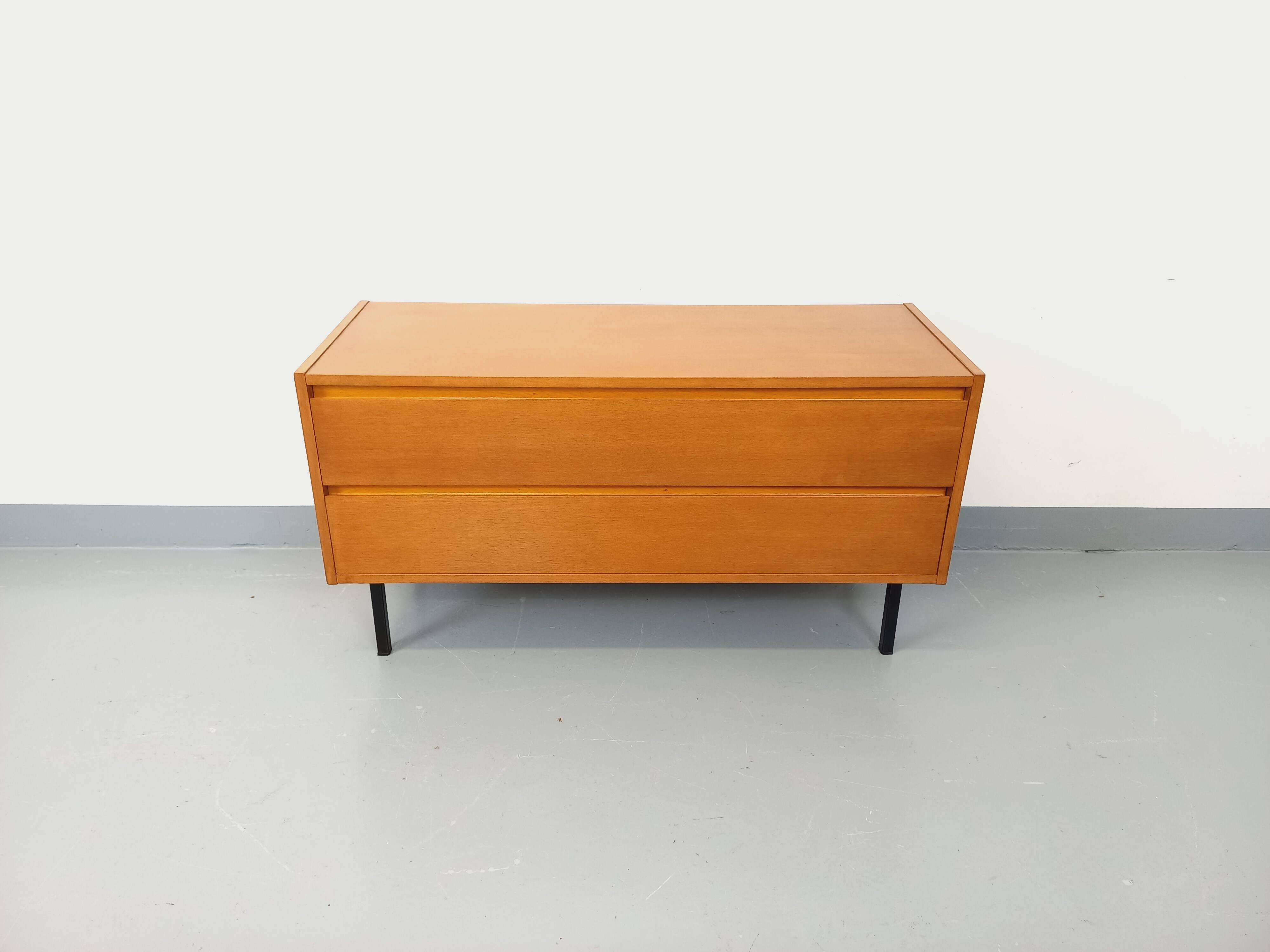 Small vintage Scandinavian sideboard in modernist style made of light oak wood.