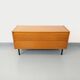 Small vintage Scandinavian sideboard in modernist style made of light oak wood.