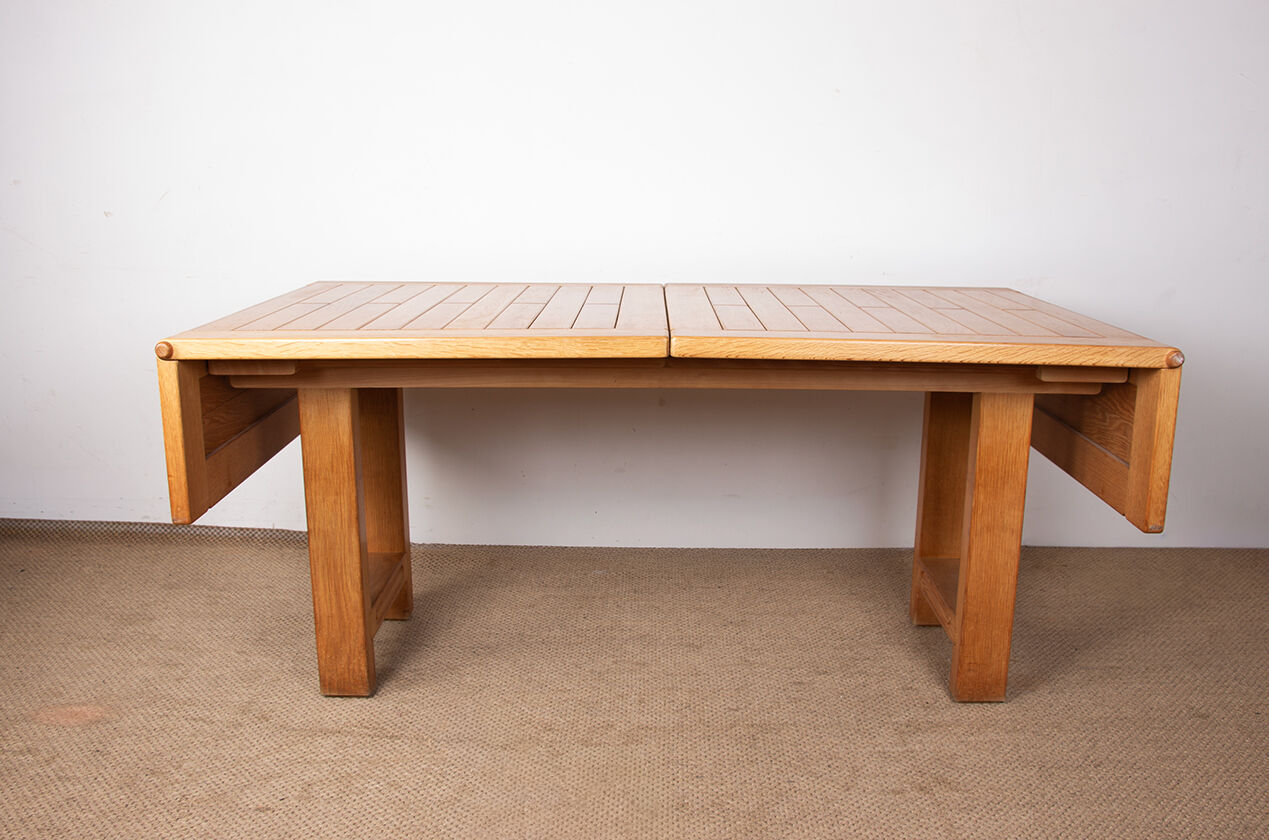 Large extendable dining table in solid oak by Guillerme and Chambron.