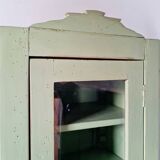 Small glass cabinet in green colour.