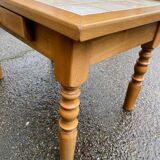 Light solid wood coffee table with tiles and a drawer.